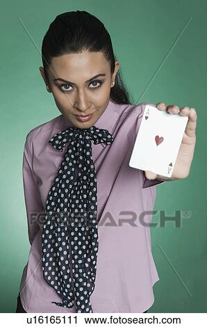 Stock Image - Businesswoman showing ace of hearts. Fotosearch