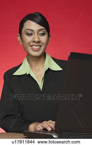 Picture - Businesswoman using a laptop. Fotosearch