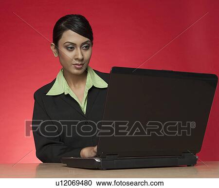 Businesswoman using a laptop View Large Photo Image Stock Image - Businesswoman using a laptop. Fotosearch