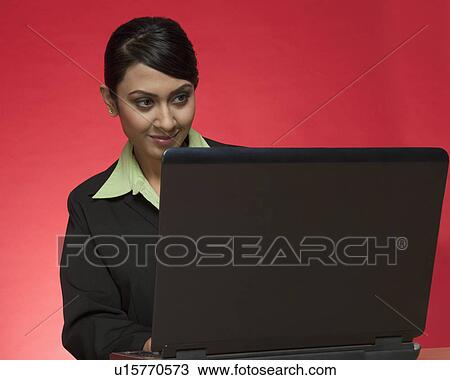Stock Image - Businesswoman using a laptop. Fotosearch