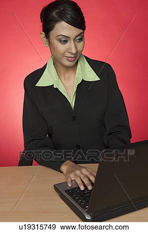Stock Photo - Businesswoman using a laptop. Fotosearch