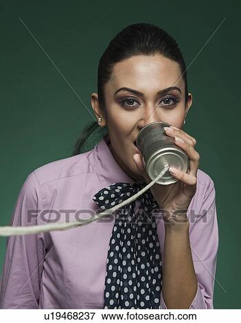 Businesswoman using a tin can phone View Large Photo Image Stock Photo - Businesswoman using a tin can phone. Fotosearch