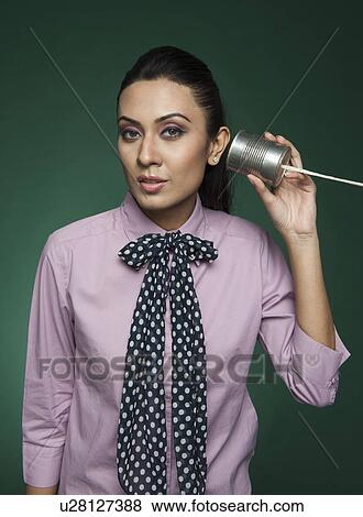 Businesswoman using a tin can phone View Large Photo Image Stock Photo - Businesswoman using a tin can phone. Fotosearch