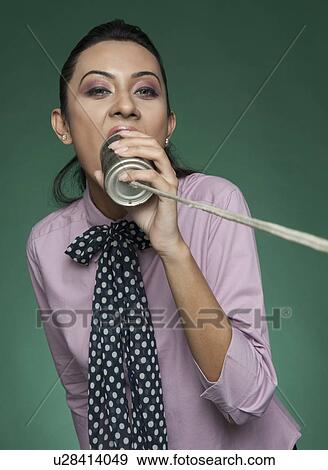 Businesswoman using a tin can phone View Large Photo Image Stock Photo - Businesswoman using a tin can phone. Fotosearch