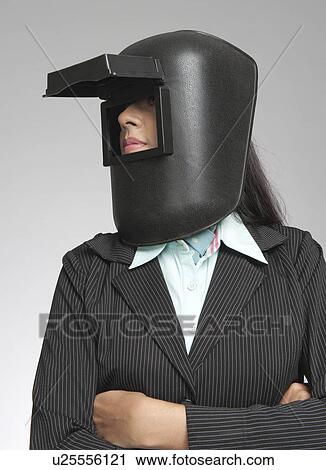 Businesswoman wearing a welding mask View Large Photo Image Stock Image - Businesswoman wearing a welding mask. Fotosearch
