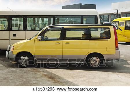 Stock Image - Car and buses at a parking lot, Macao, China. Fotosearch