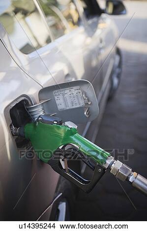 Car being refueled at a gas station, New Delhi, India View Large Photo Image Picture - Car being refueled at a gas station, New Delhi, India. Fotosearch
