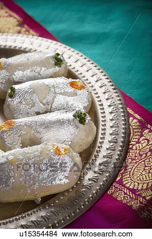 Picture - Cham cham a traditional Indian sweet made from chhena (cottage cheese) and khoya (solid milk). Fotosearch