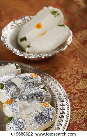 Stock Image - Cham cham a traditional Indian sweet made from chhena (cottage cheese) and khoya (solid milk). Fotosearch