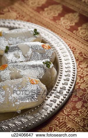 Cham cham a traditional Indian sweet made from chhena (cottage cheese) and khoya (solid milk) View Large Photo Image Stock Photo - Cham cham a traditional Indian sweet made from chhena (cottage cheese) and khoya (solid milk). Fotosearch