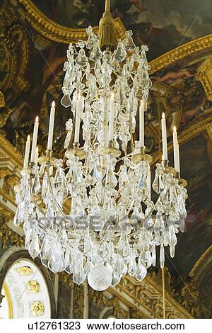 Stock Image - Chandelier hanging in the corridor of a palace, Hall Of Mirrors, Chateau de Versailles, Versailles, Paris, France. Fotosearch