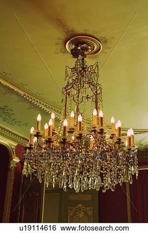 Stock Photograph - Chandelier in a museum, Musee du Louvre, Paris, France. Fotosearch
