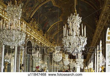 Chandeliers hanging in the corridor of a palace, Hall Of Mirrors, Chateau de Versailles, Versailles, Paris, France View Large Photo Image Stock Photo - Chandeliers hanging in the corridor of a palace, Hall Of Mirrors, Chateau de Versailles, Versailles, Paris, France. Fotosearch