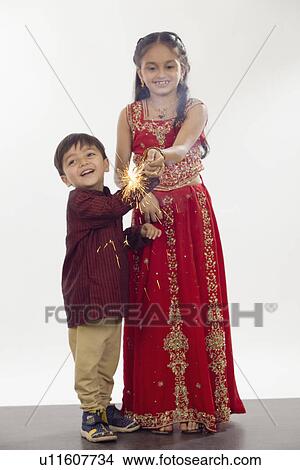 Picture - Children celebrating Diwali with sparklers. Fotosearch