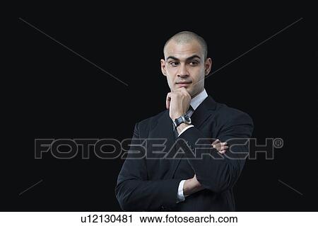 Stock Image - Close-up of a businessman thinking. Fotosearch