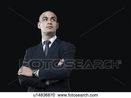 Close-up of a businessman thinking View Large Photo Image Stock Image - Close-up of a businessman thinking. Fotosearch
