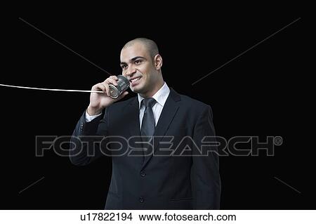 Close-up of a businessman using a tin can phone View Large Photo Image Picture - Close-up of a businessman using a tin can phone. Fotosearch