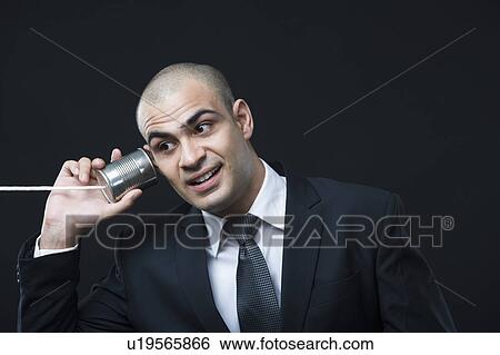 Close-up of a businessman using a tin can phone View Large Photo Image Stock Photograph - Close-up of a businessman using a tin can phone. Fotosearch