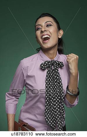 Stock Image - Close-up of a businesswoman cheering. Fotosearch