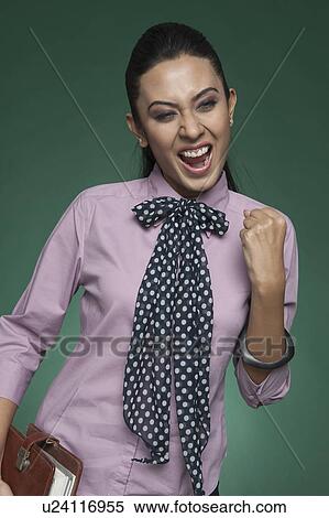 Stock Photography - Close-up of a businesswoman cheering. Fotosearch