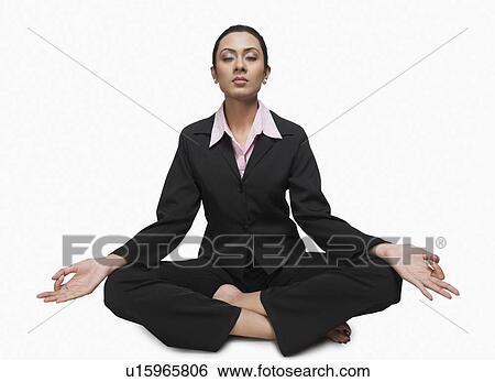 Close-up of a businesswoman meditating View Large Photo Image Stock Photograph - Close-up of a businesswoman meditating. Fotosearch