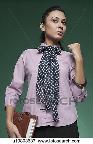 Stock Photo - Close-up of a businesswoman raising fist. Fotosearch