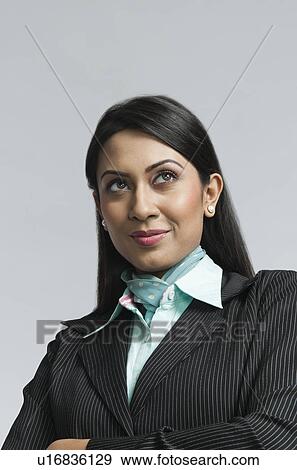 Close-up of a businesswoman thinking View Large Photo Image Stock Photo - Close-up of a businesswoman thinking. Fotosearch