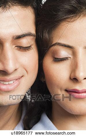 Close-up of a couple smiling View Large Photo Image Stock Photo - Close-up of a couple smiling. Fotosearch