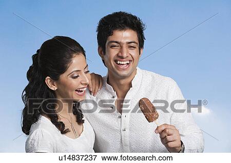 Stock Photo - Close-up of a couple with an ice cream. Fotosearch