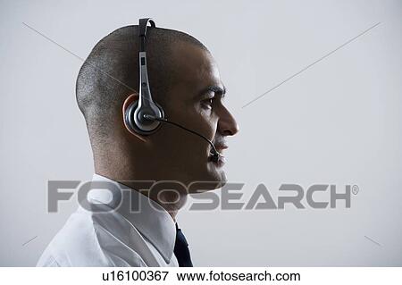Stock Photo - Close-up of a customer service representative wearing a headset. Fotosearch