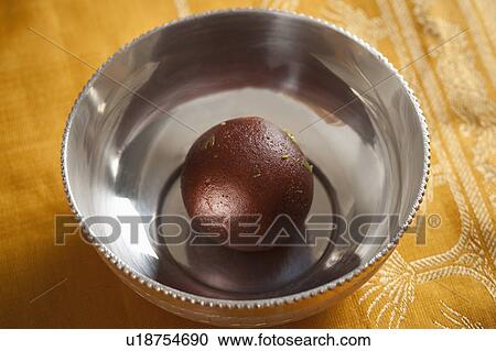 Stock Image - Close-up of a gulab jamun (a popular traditional Indian sweet). Fotosearch