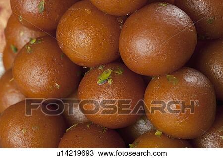 Stock Image - Close-up of a heap of gulab jamuns (a popular traditional Indian sweet). Fotosearch