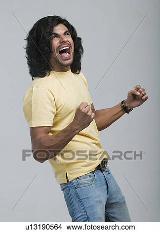 Close-up of a man cheering View Large Photo Image Picture - Close-up of a man cheering. Fotosearch