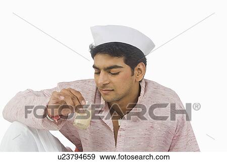 Close-up of a man drinking tea View Large Photo Image Stock Photo - Close-up of a man drinking tea. Fotosearch