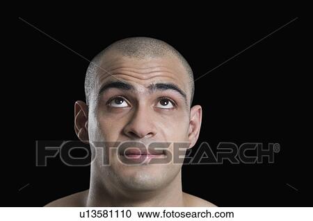 Stock Image - Close-up of a man looking up. Fotosearch