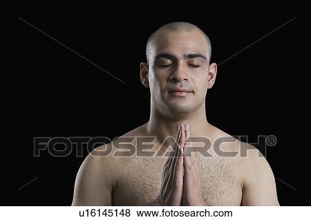 Stock Photo - Close-up of a man meditating. Fotosearch