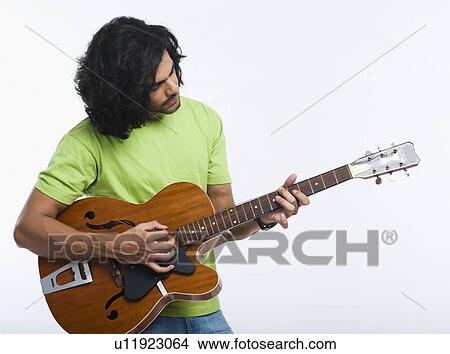 Close-up of a man playing a guitar View Large Photo Image Picture - Close-up of a man playing a guitar. Fotosearch