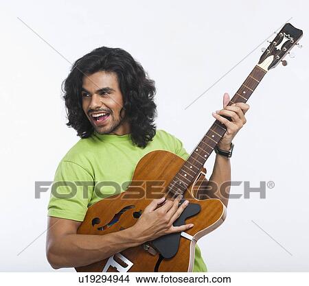 Close-up of a man playing a guitar View Large Photo Image Picture - Close-up of a man playing a guitar. Fotosearch
