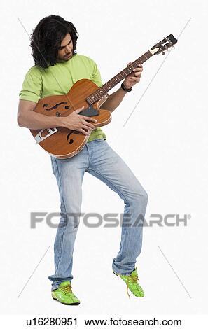 Close-up of a man playing a guitar View Large Photo Image Stock Image - Close-up of a man playing a guitar. Fotosearch