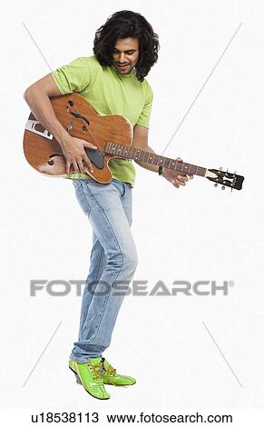 Close-up of a man playing a guitar View Large Photo Image Stock Image - Close-up of a man playing a guitar. Fotosearch