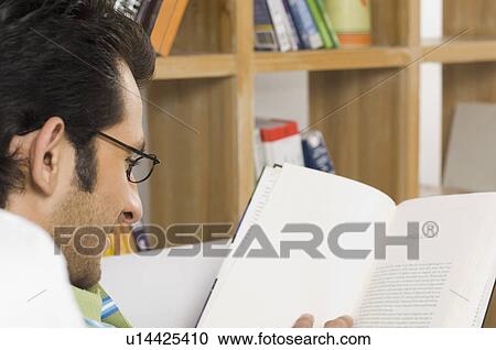 Stock Image - Close-up of a man reading a book. Fotosearch