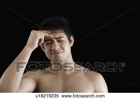 Close-up of a man suffering from a headache View Large Photo Image Stock Photography - Close-up of a man suffering from a headache. Fotosearch
