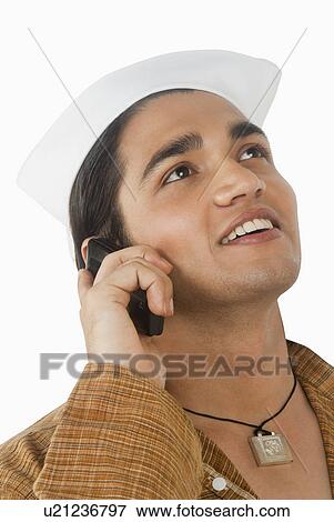 Close-up of a man talking on a mobile phone View Large Photo Image Stock Photo - Close-up of a man talking on a mobile phone. Fotosearch