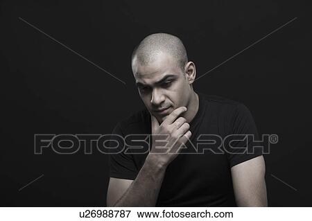 Stock Photo - Close-up of a man thinking. Fotosearch