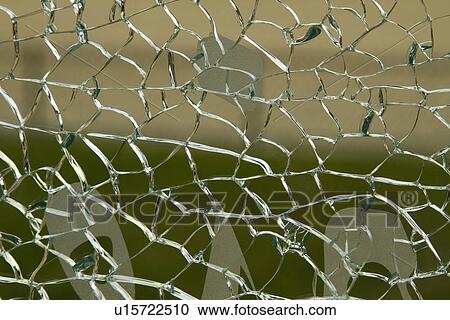 Stock Image - Close-up of a shattered glass. Fotosearch