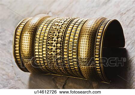 Close-up of a traditional golden armlet View Large Photo Image Stock Photograph - Close-up of a traditional golden armlet. Fotosearch