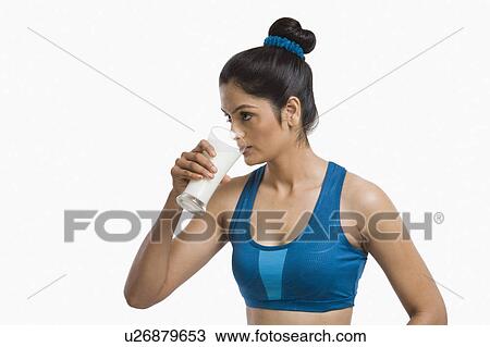 Close-up of a woman drinking milk View Large Photo Image Stock Image - Close-up of a woman drinking milk. Fotosearch
