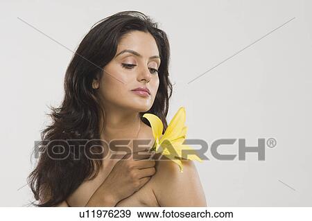 Stock Photo - Close-up of a woman holding a Tiger Lily flower. Fotosearch