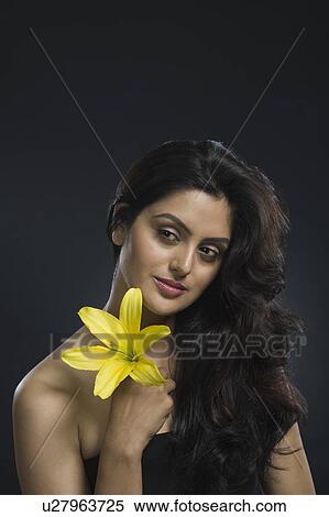 Close-up of a woman holding a Tiger Lily flower View Large Photo Image Stock Photography - Close-up of a woman holding a Tiger Lily flower. Fotosearch