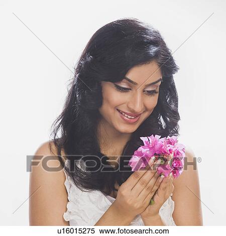 Close-up of a woman holding flowers View Large Photo Image Stock Photography - Close-up of a woman holding flowers. Fotosearch